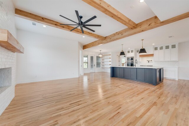 unfurnished living room featuring a fireplace, light wood-type flooring, a ceiling fan, and recessed lighting
