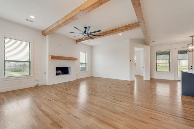 1001 Devoss Ct, Caddo Mills, TX 75135 - unfurnished living room with light wood-type flooring, visible vents, ceiling fan with notable chandelier, and beam ceiling