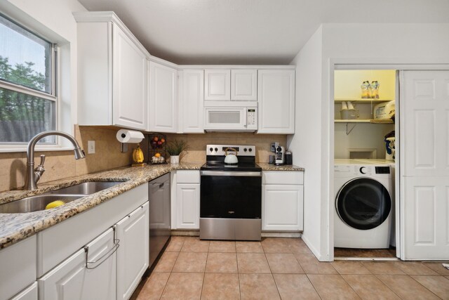 kitchen featuring electric range, a sink, washer / clothes dryer, white microwave, and dishwashing machine