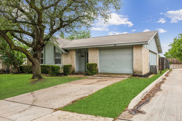 ranch-style home featuring fence, a front lawn, a garage, board and batten siding, and driveway