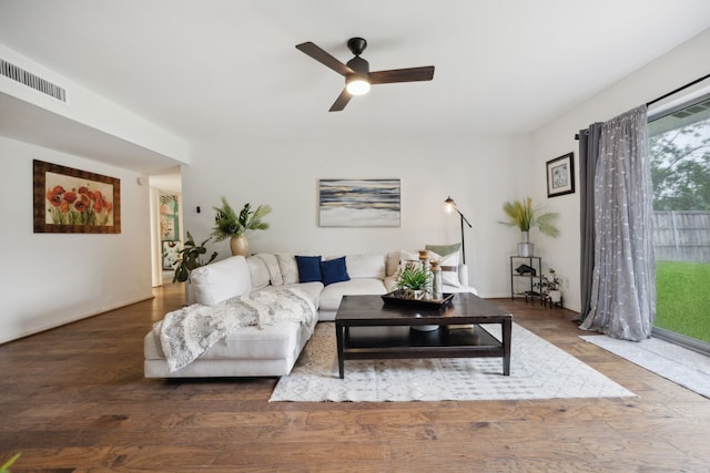 living room with visible vents, ceiling fan, and wood finished floors