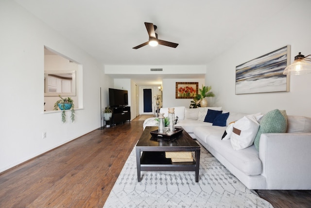 living room featuring baseboards, ceiling fan, wood finished floors, and visible vents
