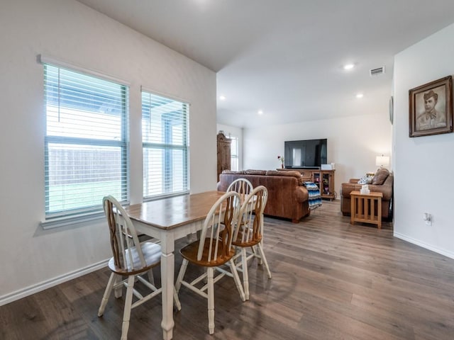 dining room featuring wood finished floors, visible vents, and a healthy amount of sunlight