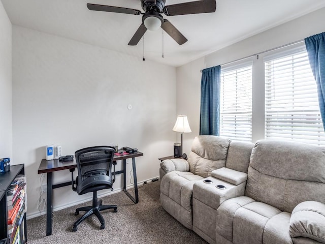 home office featuring baseboards, a ceiling fan, and carpet
