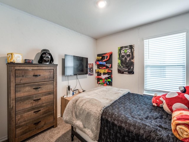 carpeted bedroom featuring crown molding