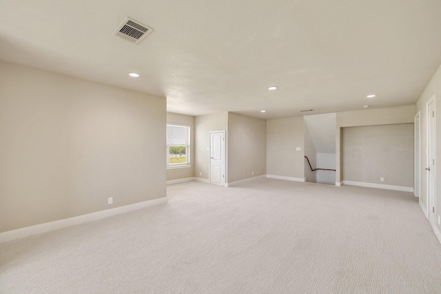 basement featuring visible vents, recessed lighting, light carpet, and baseboards