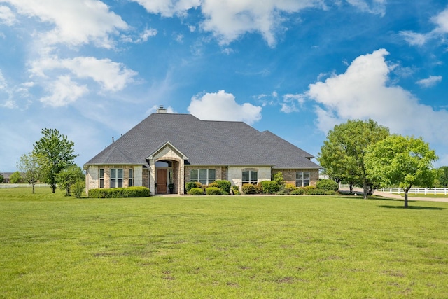view of front of property featuring a chimney and a front lawn