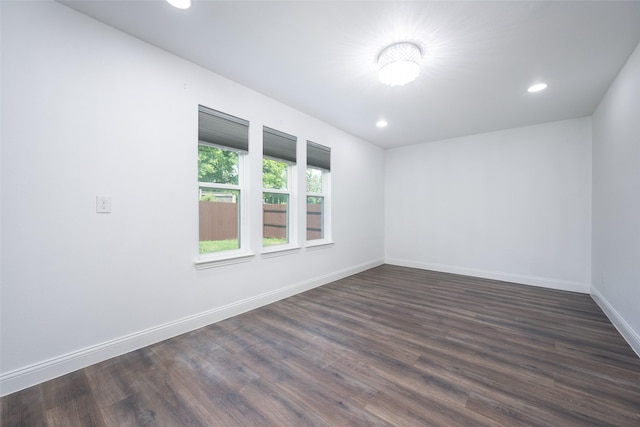 spare room with dark wood-style floors, recessed lighting, and baseboards