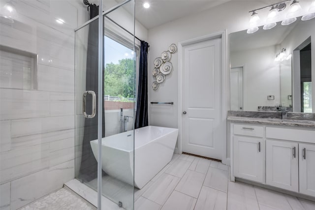 full bath with a freestanding tub, recessed lighting, a shower stall, and vanity