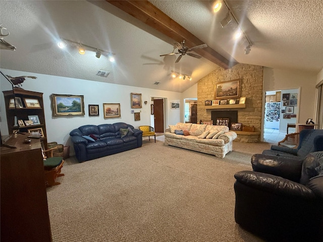 carpeted living area featuring a textured ceiling, ceiling fan, visible vents, track lighting, and vaulted ceiling with beams