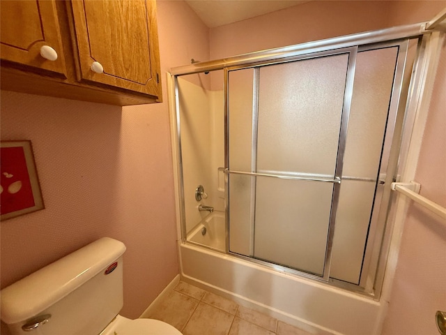 full bathroom with tile patterned floors, combined bath / shower with glass door, and toilet
