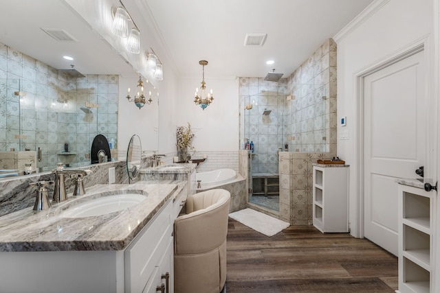 11900 Wind Hollow Ct, Tolar, TX 76476 - full bathroom featuring tiled shower, a garden tub, vanity, wood finished floors, and a chandelier