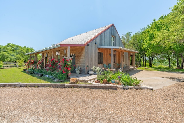11900 Wind Hollow Ct, Tolar, TX 76476 - view of side of home with a yard and metal roof