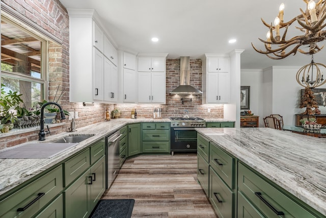 11900 Wind Hollow Ct, Tolar, TX 76476 - kitchen featuring green cabinets, wall chimney exhaust hood, appliances with stainless steel finishes, white cabinetry, and light wood-style floors