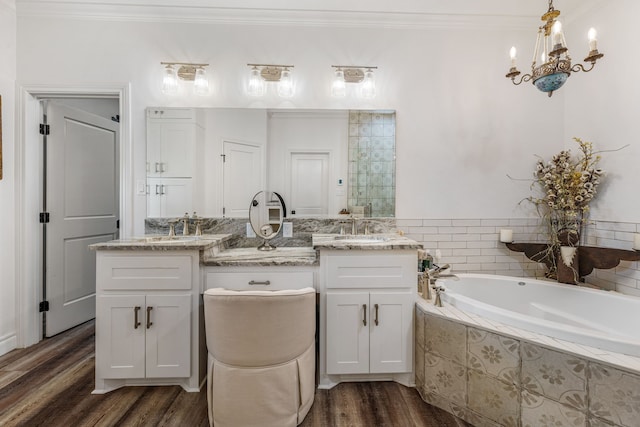 11900 Wind Hollow Ct, Tolar, TX 76476 - bathroom featuring ornamental molding, wood finished floors, a bath, double vanity, and a chandelier