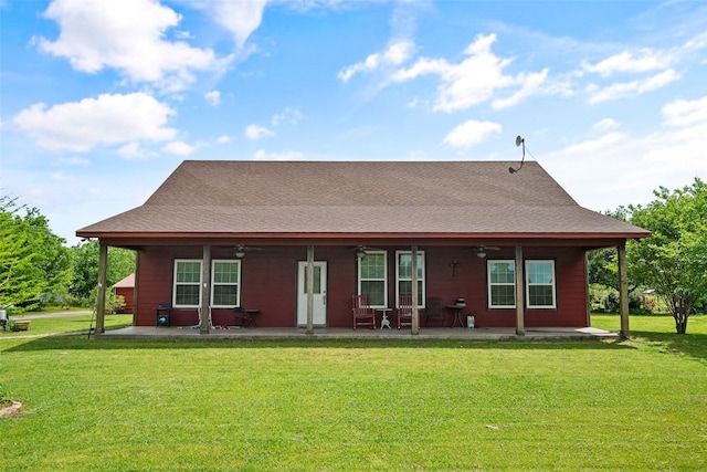 back of property with a patio, ceiling fan, and a lawn