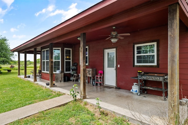 exterior space featuring a yard and ceiling fan