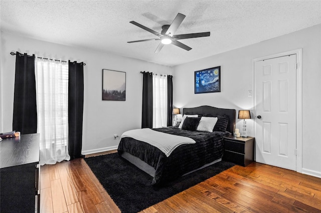 bedroom featuring a ceiling fan, a textured ceiling, and hardwood / wood-style floors