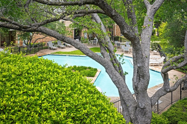 view of home's community featuring a patio, fence, and a pool