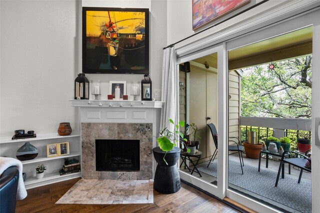 interior space with a healthy amount of sunlight, a fireplace, and wood finished floors