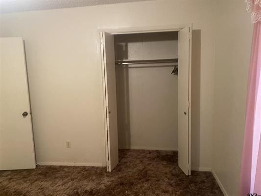 unfurnished bedroom featuring a closet and carpet floors