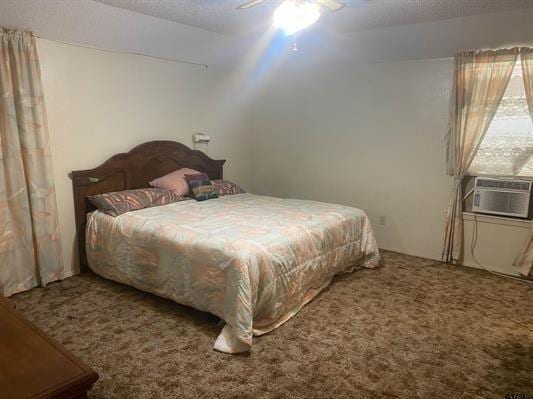 bedroom with cooling unit, ceiling fan, and carpet floors
