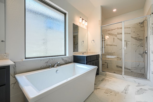 bathroom featuring recessed lighting, vanity, marble finish floor, a marble finish shower, and a freestanding bath