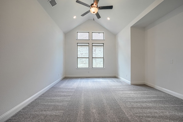 carpeted empty room featuring a ceiling fan, visible vents, lofted ceiling, and baseboards