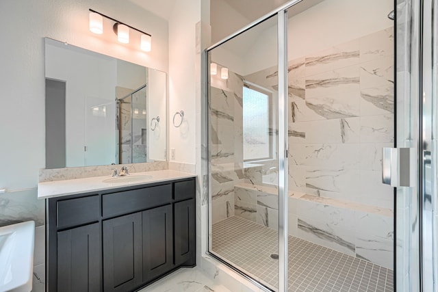 bathroom with a marble finish shower, marble finish floor, and vanity
