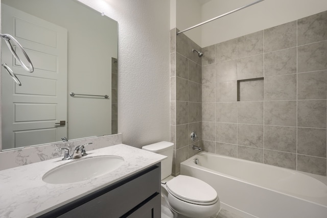 full bath with a textured wall, vanity, toilet, and  shower combination