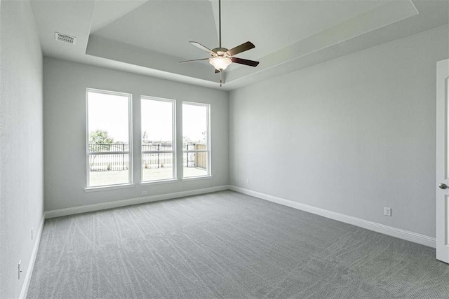 3406 Tilley Ct, Rockwall, TX 75087 - carpeted empty room with a tray ceiling, a ceiling fan, and baseboards