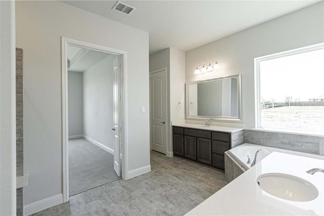 3406 Tilley Ct, Rockwall, TX 75087 - bathroom with vanity, a garden tub, and baseboards