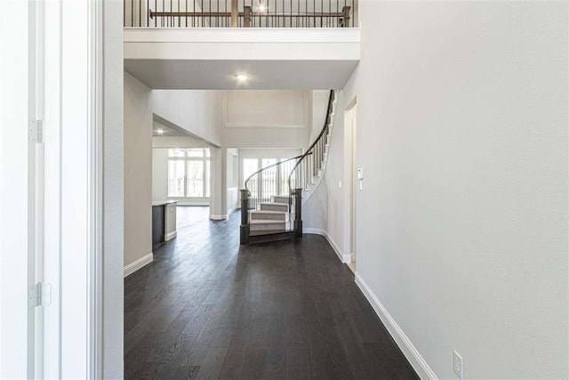 3406 Tilley Ct, Rockwall, TX 75087 - foyer with dark wood-style floors, baseboards, stairway, and a towering ceiling