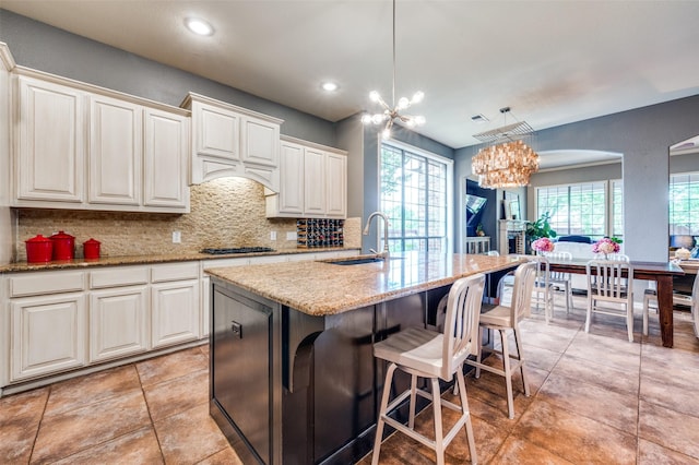 881 Willowmist Dr, Prosper, TX 75078 - kitchen featuring a chandelier, backsplash, light stone countertops, light tile patterned floors, and recessed lighting