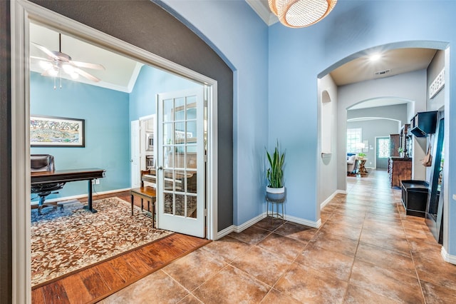 881 Willowmist Dr, Prosper, TX 75078 - tiled entryway featuring a ceiling fan, arched walkways, crown molding, and lofted ceiling