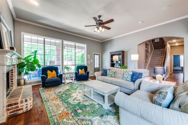 881 Willowmist Dr, Prosper, TX 75078 - living area featuring a ceiling fan, wood finished floors, stairs, arched walkways, and a fireplace