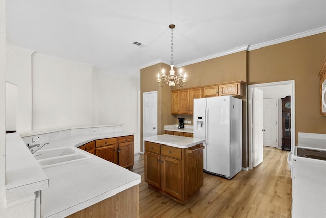 kitchen with light wood-style flooring, white fridge with ice dispenser, a chandelier, a sink, and visible vents
