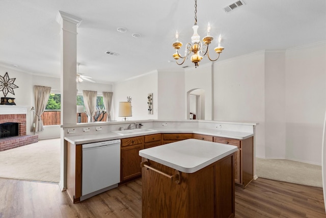 kitchen featuring a sink, visible vents, white dishwasher, open floor plan, and a large island