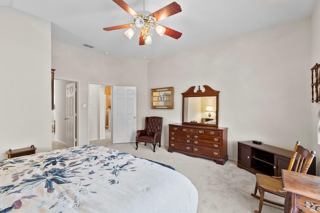 bedroom featuring baseboards, visible vents, a ceiling fan, and light colored carpet