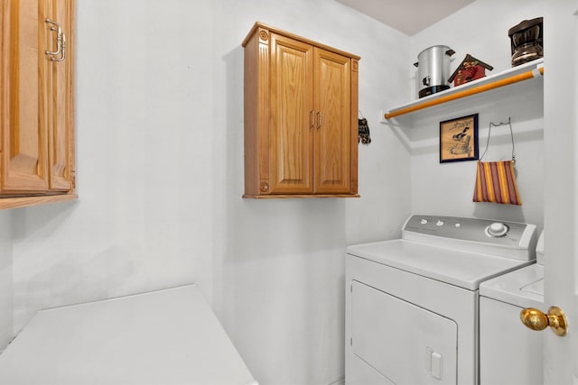 clothes washing area with cabinet space and washing machine and clothes dryer