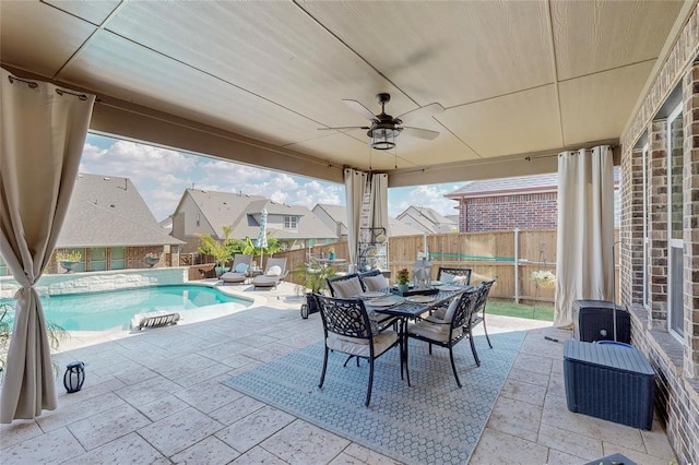 view of patio / terrace featuring a fenced in pool, ceiling fan, outdoor dining area, and a fenced backyard