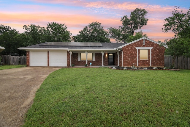 ranch-style home featuring fence, a porch, brick siding, and a garage