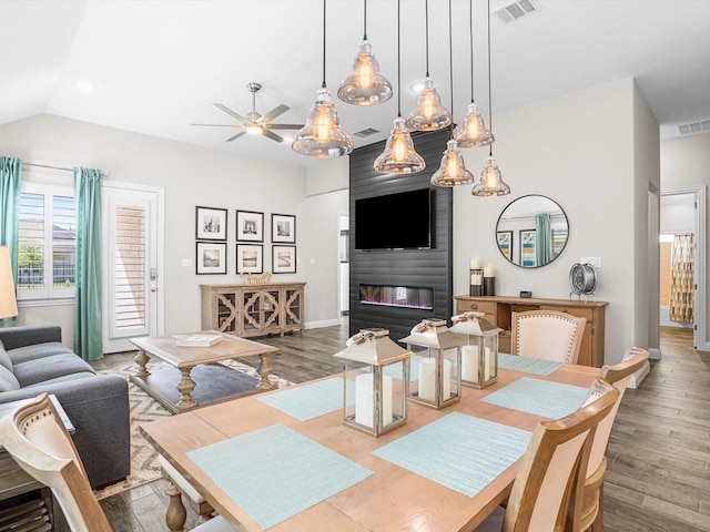 dining space featuring visible vents, ceiling fan, and wood finished floors