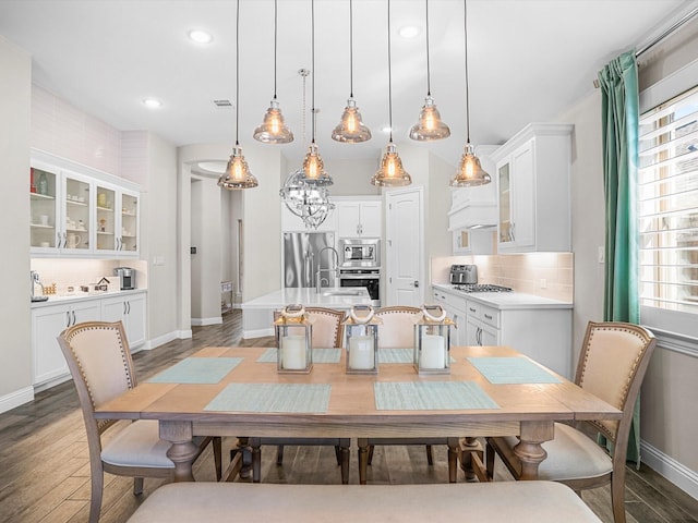 dining space with baseboards, recessed lighting, wood finished floors, and visible vents