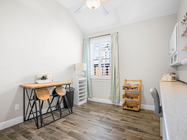 office space with dark wood-style floors, a ceiling fan, lofted ceiling, and baseboards