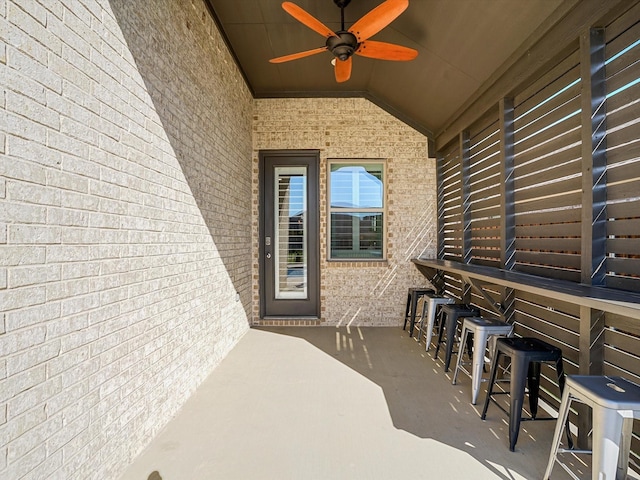 view of patio / terrace featuring outdoor dry bar and ceiling fan
