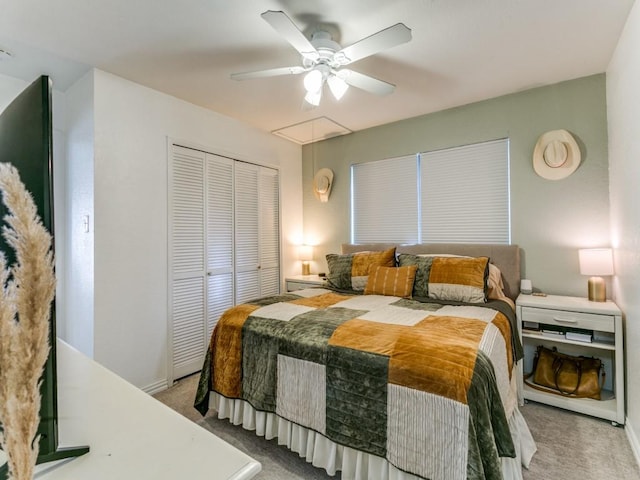 bedroom with attic access, a ceiling fan, carpet floors, and a closet