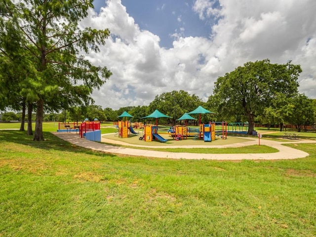 community jungle gym featuring a lawn