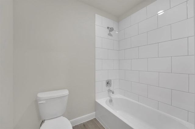 full bath featuring wood finished floors, toilet, bathtub / shower combination, and baseboards