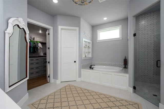 450 County Road 2411, Valley View, TX 76272 - full bathroom featuring a garden tub, a walk in closet, a shower stall, and tile patterned floors